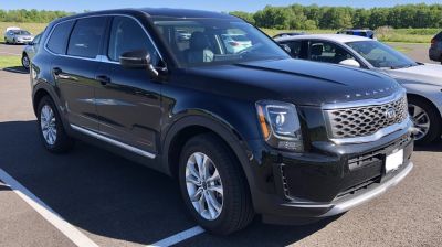 Front-side view of a black SUV with distinctive grille and headlights