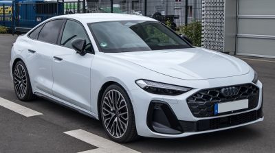 Modern sedan front profile with LED headlights and complex grille