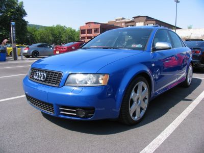 Blue sedan with front grille and alloy wheels