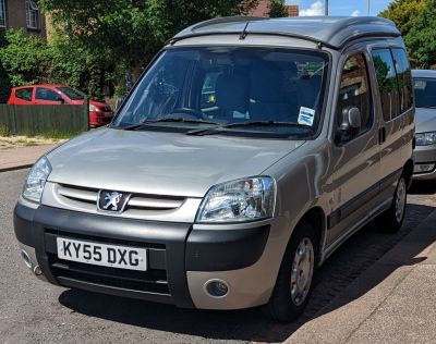 Front and side view of van with black bumper and clear headlights