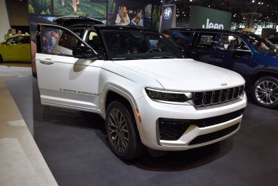 White modern SUV with bold grille and open door front view