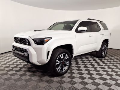 Bold front grille and multi-spoke alloy wheels on white SUV