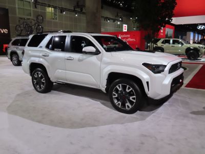 White SUV with angular headlights, bold grille, 5-spoke alloy wheels