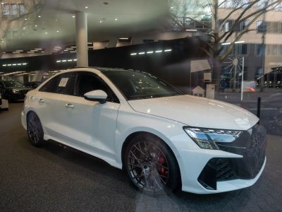 Facelift RS3 sedan front grille, headlights, and multi-spoke wheels with red brake calipers