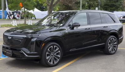 Black electric luxury SUV with LED headlights and aerodynamic wheels
