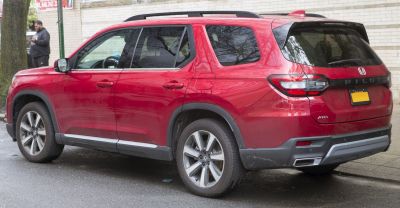 Red SUV rear side view with AWD badge and alloy wheels