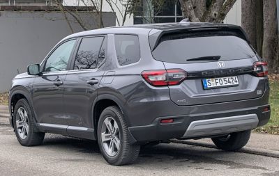 Rear-side view of modern SUV with tail lights and AWD badge