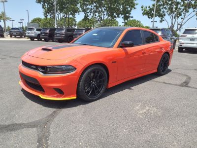 Bright sedan with hood scoop, black wheels, and front splitter accents