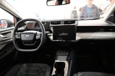 Modern car interior with dashboard and multifunction steering wheel