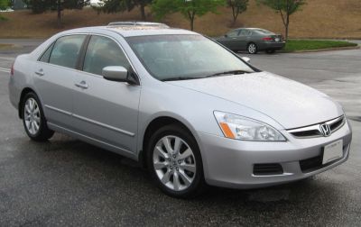 Silver midsize sedan with alloy wheels and clear front headlights