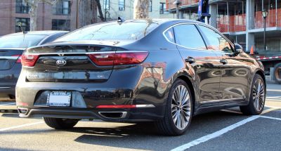 Rear view of sedan with dual exhausts and sleek taillights