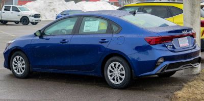 Rear side profile of blue 2022 sedan with updated taillights and alloy wheels