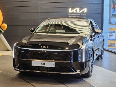 Front view of black sedan with vertical LED headlights and sleek grille