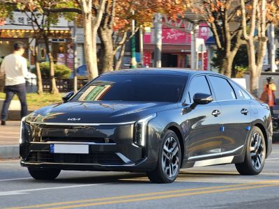 Modern luxury sedan with distinctive LED headlights and sleek front design