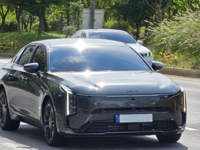 Front view of sleek sedan with vertical LED headlights and glossy finish