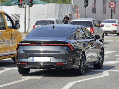 Rear view with sleek LED tail lights and aerodynamic sedan design
