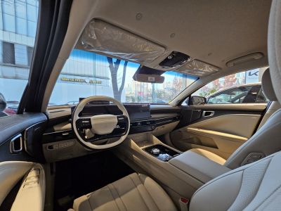 Luxury car interior with digital dashboard and beige leather seating