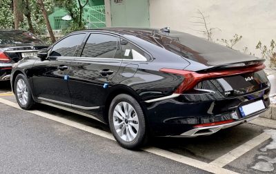 Rear exterior of a sedan with continuous LED tail light strip and alloy wheels