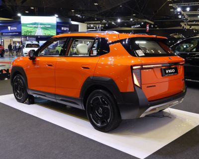 Rear and side view of a bright orange modern SUV
