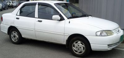 White four-door sedan with rounded headlights and simple design