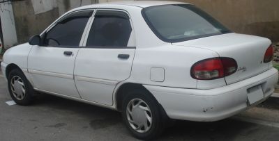 White sedan with rounded tail lights and tinted windows