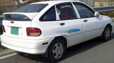 Rear side view of hatchback with spoiler and alloy wheels