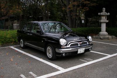 Retro-styled sedan with vintage grille and round headlights