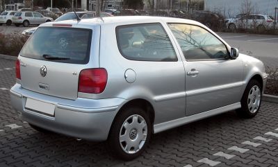 Silver compact hatchback side rear view with red tail lights