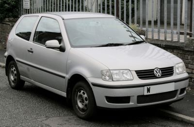Front angled view of silver compact hatchback with distinct headlights and grille