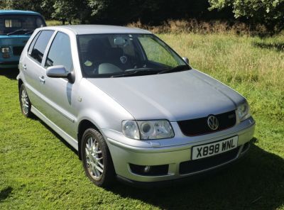 Silver hatchback showing front-left exterior with headlights and grille