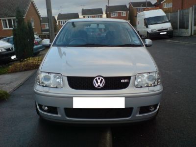 Close-up of front grille and headlights on compact hatchback.