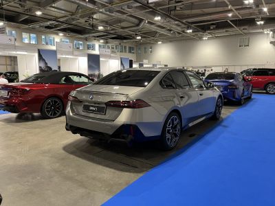 Luxury sedan rear with LED taillights and sporty twin exhausts