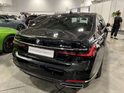 Rear view of luxury sedan with modern LED taillights and dual exhaust