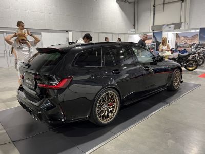Black luxury performance wagon with bronze multi-spoke wheels and aggressive rear diffuser
