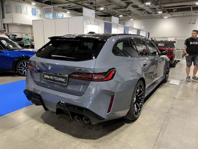 Sporty station wagon rear with quad exhausts and distinctive tail lights.