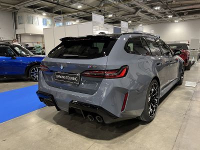 Aggressive rear design with quad exhausts and sleek taillights