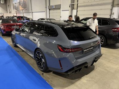 Rear and side view of a sporty luxury station wagon with sleek tail lights and black alloy wheels.