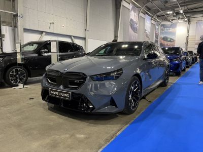 Front and side view of a performance touring vehicle with distinctive grille and sport wheels