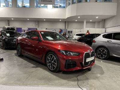 Red sedan with large kidney grille and sleek headlights