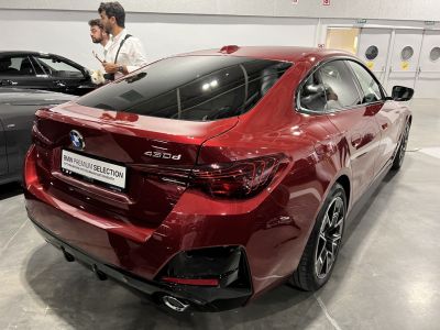 Rear design of a red 4-door gran coupe with distinctive taillights and sporty diffuser.