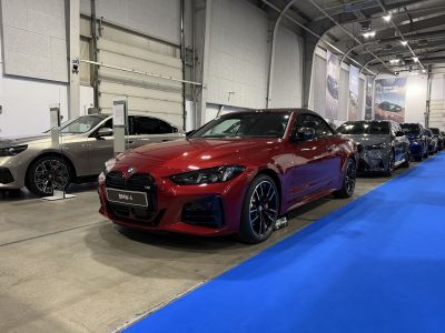 Red convertible with large kidney grille and black rims