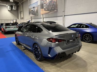 Rear view of sleek 2025 BMW 2 Series Gran Coupe with quad exhaust and sporty design