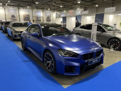 Matte blue sporty coupe with aggressive front and stylish wheels
