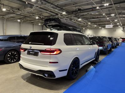Rear view of SUV with roof cargo box and black wheels