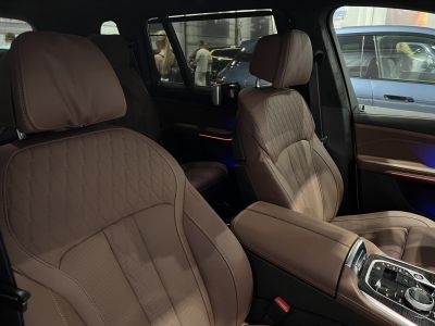 Brown leather front seats with detailed stitching and luxury console controls