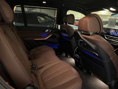 Luxury brown leather rear seats with ambient lighting and advanced controls