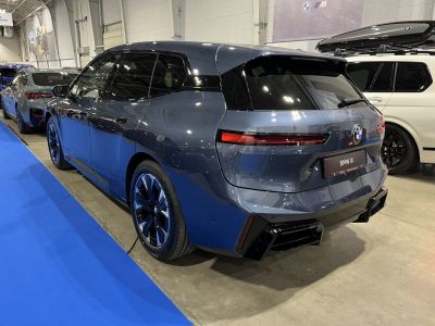 Rear and side view of a sleek modern electric SUV with distinctive tail lights and aerodynamic design