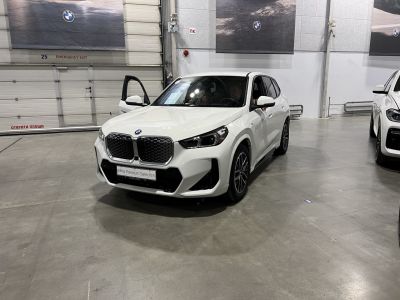 White modern SUV showing front angled view with distinctive grille