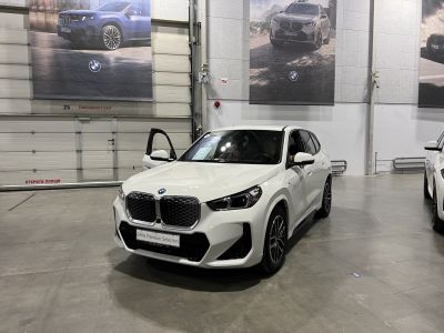 Large kidney grille and LED headlights on front of white SUV