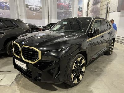 Luxury black SUV with gold-accented dual kidney grille and unique alloy wheels